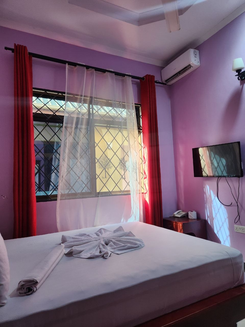 Pink-toned bedroom with garden view
